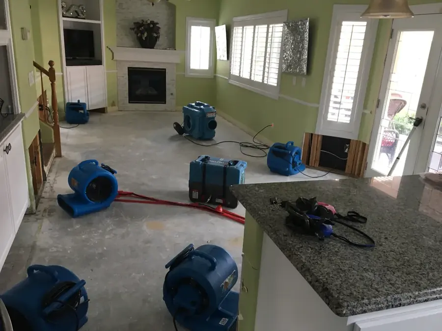 Restoration technician drying a flooded Bonney Lake, WA home with air movers
